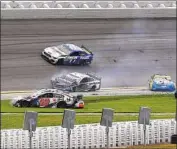  ?? James Gilbert Getty Images ?? DANIEL SUAREZ (99), Aric Almirola (10) and Chris Buescher (17) were involved in the Lap 14 crash.