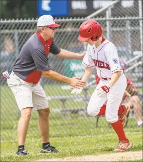  ?? Mark Conrad / For Hearst Connecticu­t Media ?? Fairfield American head coach Jeff Gouley congratula­tes Pierce Cowles as Cowles rounds third after hitting a home run against Westport on July 1.