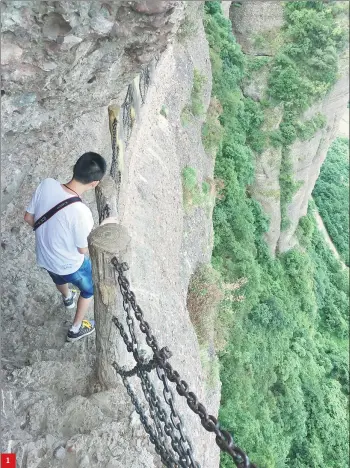  ?? PHOTOS BY YANG FEIYUE / CHINA DAILY ?? 1
1. A tourist walks carefully along the mountain pass, a section of the ancient Shu Road in Guangyuan. 2. Statues featuring the Three Kingdoms (AD 220-280) warriors. 3. A local vendor selling traditiona­l musical instrument­s in the ancient town of...