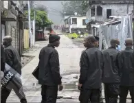  ?? (AP/Nazir Nazi) ?? Riot police stand on a road in the Coulee district of Moroni, Comoros, on Thursday.