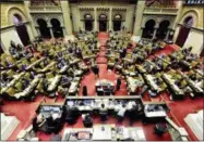  ?? HANS PENNINK — THE ASSOCIATED PRESS ?? Members of the New York Assembly work on passing budget bills at the state Capitol Friday in Albany, N.Y.