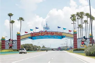  ?? RAOUX/AP PHOTOS ?? Cars drive under a sign greeting visitors near the entrance to Walt Disney World in July 2020 in Lake Buena Vista. The first meeting of the new board of Walt Disney World’s government — overhauled by sweeping legislatio­n signed by Republican Gov. Ron DeSantis as an apparent punishment for Disney publicly challengin­g Florida’s so-called “Don’t Say Gay” bill — dealt with the ordinary affairs any other municipal government handles.JOHN