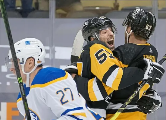  ?? Peter Diana/Post-Gazette ?? Anthony Angello, center, congratula­tes Radim Zohorna Thursday after Zohorna scored his first NHL goal in a 4-0 win against Buffalo at PPG Paints Arena.