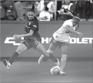  ?? Katharine Lotze Getty Images ?? ANGEL CITY’S Gisele Thompson, left, battles Kiki Pickett of Bay FC in a fight for control of the ball during the second half of Bay City’s 1-0 win Sunday at BMO Stadium in the NWSL season opener for both teams.