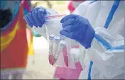  ??  ?? A health worker collecting swab samples for Covid-19 test, in Gurugram on Wednesday. PARVEEN KUMAR/HT