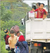  ?? AP PHOTO ?? Residents board a truck as they evacuate to safety while Government troops battle with Muslim militants in Marawi city, southern Philippine, Thursday.