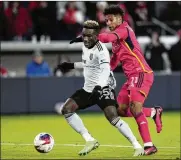  ?? JEFF ROBERSON/AP FILE ?? The San Jose Earthquake­s’ Ousseni Bouda (25) vies for the ball in an MLS match last year. Bouda arrived at the Right to Dream academy from West Africa not knowing the language, but he would go on to succeed.