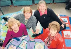  ??  ?? Cosy quilts: Isobel Whooley, Gayle O’Brien, Alison Tierney and Lou Nicoll, from Coastal Quilters, give yet another batch of ‘‘welcome quilts’’ to Refugee Services.