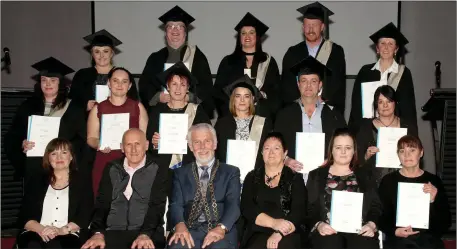  ??  ?? The recipients of QQI Level 5 in Healtcare and Business Studies, with their certificat­es.