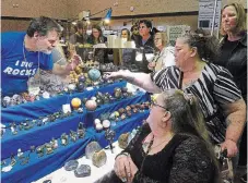  ?? ?? Geologist Chris Fouts shows spheres to collectors Patty McKellar, left, and Catherine Martin during the return of the 29th annual Kawartha Rock and Fossil Club’s Gem, Mineral and Fossil Show March 2.