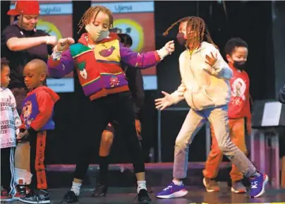  ?? K.C. ALFRED U-T ?? Children dance on the first day of Kwanzaa at the WorldBeat Cultural Center in Balboa Park. Kwanzaa, a holiday celebratin­g African American culture, runs for seven days. Three more events are planned at the center this week.