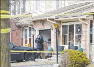  ?? CP PHOTO ?? A forensic investigat­or takes photograph­s at a home in Ajax, Ont., on Thursday.