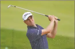  ?? The Associated Press ?? LEADING THE WAY: Justin Thomas, of the United States, plays a shot from a bunker on the 17th hole Thursday during the first round of the US Open Golf Championsh­ip in Mamaroneck, N.Y.