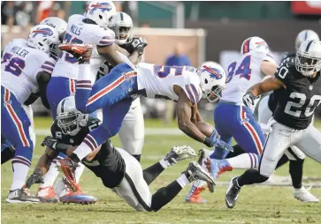  ?? DAN HONDA/STAFF ?? The Raiders’ Khalil Mack (52) goes low to make a tackle on the Bills’ LeSean McCoy on Sunday at the Oakland Coliseum.