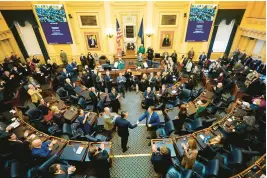  ?? STEVE HELBER/AP ?? Gov. Glenn Youngkin, center, arrives to deliver his State of the Commonweal­th address before a joint session of the Virginia General Assembly in the House chambers at the Capitol on Jan. 17, 2022, in Richmond.