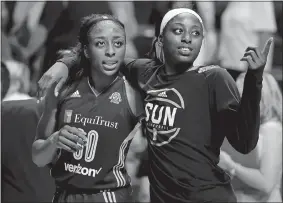  ?? JESSICA HILL/AP PHOTO ?? Nneka Ogwumike of the Sparks, left, and her sister Chiney of the Sun walk off the court together at the end of a WNBA game on May 26 at Mohegan Sun Arena. Nneka Ogwumike was named WNBA MVP on Tuesday.