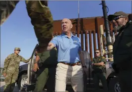  ?? JOEL MARTINEZ — THE MONITOR ?? Alejandro Mayorkas, U.S. secretary of Homeland Security, shakes hands along a section of the border wall Tuesday in La Joya, Texas.