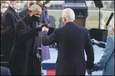  ?? ASSOCIATED PRESS ?? President-elect Joe Biden bumps fists with former President Barack Obama during Biden’s inaugurati­on Wednesday at the US Capitol in Washington.