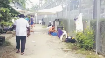  ??  ?? Asylum seekers are seen at a detention centre on Manus Island, Papua New Guinea. — Reuters photos