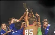  ?? CHRIS DEANTONIO - FOR DIGITAL FIRST MEDIA ?? Members of the Oley Valley boys soccer team hoist the BCIAA trophy after winning the championsh­ip over Wilson on Oct. 20.