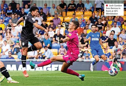  ?? ?? ■ Josh Gordon fires Barrow in front at AFC Wimbledon