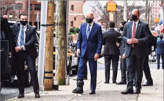  ?? Chandan Khanna / AFP via Getty Images ?? President-elect Joe Biden wears a boot after he twisted his ankle while playing with his dog, as he departs after an event at The Queen Theater in Wilmington, Del., on Tuesday.