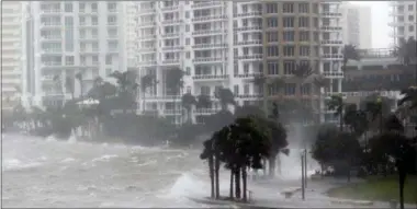  ?? THE ASSOCIATED PRESS ?? On Sept. 10, 2017, waves crash over a seawall at the mouth of the Miami River from Biscayne Bay, Fla., as storm surge from Hurricane Irma impacts Miami.