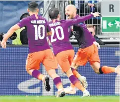  ??  ?? Job done: David Silva is hailed by namesake Bernardo and Sergio Aguero after hitting a late winner for Manchester City