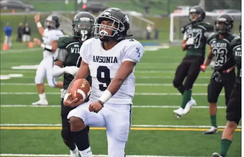  ?? Pete Paguaga / Hearst Connecticu­t Media ?? Ansonia’s Darell McKnight celebrates scoring a touchdown during a game against Wilby at Municipal Stadium in Waterbury on Thursday.