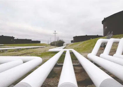  ?? NICK OXFORD/REUTERS FILES ?? Pipelines run to Enbridge.'s crude oil storage tanks in Cushing, Okla. Calgary-based TC Energy wants to use its power and storage division, which includes renewable energy, to slash planet-warming emissions as well as expand and diversify the company.