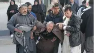  ?? RAHMAT GUL / THE ASSOCIATED PRESS ?? A distraught man is carried following a suicide attack on a Shiite Muslim cultural centre in Kabul Thursday.