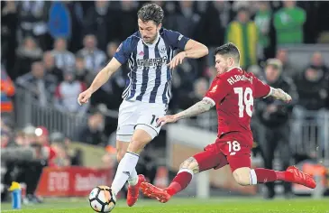  ?? AFP ?? West Brom’s Jay Rodriguez is tackled by Liverpool’s Alberto Moreno during their FA Cup fourth round match at Anfield.