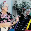  ?? Photo / Judith Lacy ?? Mamastrumm­ers’ Trish Fleet (left) and Rodnie Derrett entertain visitors to the Christmas lights in Washington Parade, Palmerston North, on Saturday.