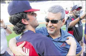  ?? CURTIS COMPTON /CCOMPTON@AJC.COM ?? Dansby Swanson gets a hug from dad Cooter before making his debut at Turner Field last week.