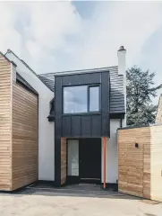  ?? ?? SHINING IN: This row, from left to right, the openplan living space is filled with natural light thanks to the wall of sliding glazed doors; the house at the front is unrecognis­able from its former incarnatio­n; Ruth and Andy’s twin daughters in one of the five bedrooms.