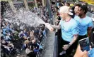  ?? Manchester City/Getty Images ?? Ederson sprays champagne from the victory parade bus. Photograph: Matt McNulty/