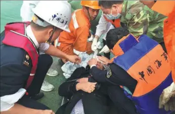  ?? PROVIDED TO CHINA DAILY ?? A sailor is treated after being pulled from the water on Tuesday, following a collision of two ships on Monday. The collision occurred at the mouth of the Pearl River in Guangdong province. All 11 sailors from the and two from the were rescued on...