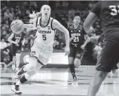  ?? JESSICA HILL AP ?? Connecticu­t’s Paige Bueckers drives to the basket during the first half of the Huskies’ rout against Mercer.