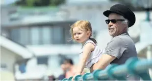  ?? Richard Swingler ?? > Marlaina Gane, aged two, looks out to sea with grandad Neil Sullivan, from Penarth Pier