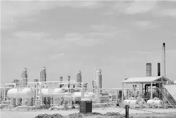  ?? — Reuters photo ?? An oil and gas processing plant fed by local shale wells is pictured along a highway outside Carrizo Springs, about 30 miles (48 km) from the Mexican border, in Dimmit County, Texas.