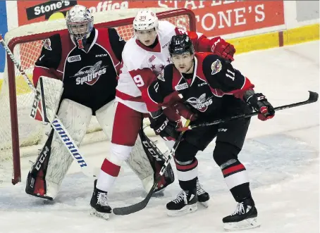  ?? PETER RUICCI/SAULT STAR ?? Sault Ste. Marie Greyhounds winger Brett Jacklin battles Windsor’s Sean Allen for position in front of netminder Kari Piiroinen on Sunday. The Spitfires rallied from a three-goal deficit only to lose on an odd-man rush in overtime.