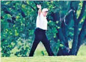  ??  ?? Donald Trump waves during a round of golf at the Trump National Golf Club in Sterling, Virginia. Right, still shunning a mask he shakes an opponent’s hand, breaching social distancing etiquette