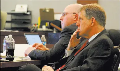  ?? Max Michor Las Vegas Review-journal ?? Defense attorney Craig Mueller, front, and Metropolit­an Police Department officer Bret Theil listen to closing arguments Tuesday at the Regional Justice Center. Theil is accused of sexually abusing a child.