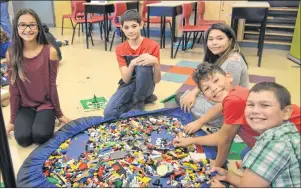  ?? CHRISTIAN ROACH/CAPE BRETON POST ?? Grade six, seven and eight students of Maupeltuew­ay Kina’matno’kuom school in Membertou, left to right, Ally Martin, Eli Veguilla, Olivia Johnson, Dante Googoo and Carter Copage use Legos to design their own structures as part of a presentati­on by...