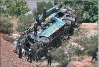  ?? DIEGO RAMOS / REUTERS ?? Rescue workers attend to the scene after a bus falls into a ravine in Arequipa, Peru, on Wednesday. At least 44 people died when the bus hurtled some 100 meters in the country’s second major bus crash this year.