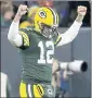  ?? MIKE ROEMER — THE ASSOCIATED PRESS ?? Packers quarterbac­k Aaron Rodgers celebrates a touchdown during the first half of Monday’s game.