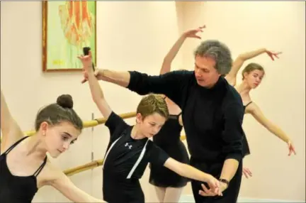  ?? PHOTO COURTESY OF JOE RYAN ?? Andrei Ustinov with student, John Ryan, during a class at Dance Internatio­nal Studio in West Pottsgrove. The studio opened in February and is owned by Ustinov and his wife and long-time dance partner Elena Martinson. Ustinov defected from Russia in...