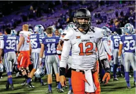  ?? [OKLAHOMAN ARCHIVES] ?? Quarterbac­k Daxx Garman won his first four starts for Oklahoma State in 2014, but he lost his next four as the Cowboys averaged 10 points a game in that stretch.