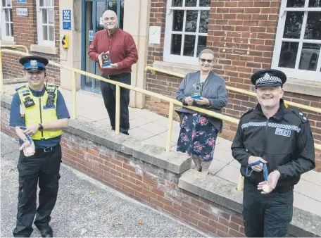  ??  ?? From left, PCSO Daniel Hawksby, Cllr Neil MacKnight, Cllr Juliana Heron and Inspector Nick Gjorven with some of the trophies and medals.