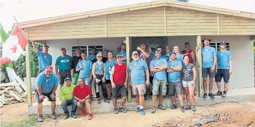  ?? HOPE AGUA VITA PHOTOS ?? Doug Tarry, front left, and the Hope Agua Vita builders who volunteere­d their time and money this past May to rebuild homes destroyed by Hurricane Maria.